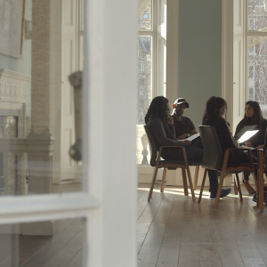 People sit round a table working and discussing