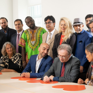 Refugees from 7 decades mark the 70th anniversary of the UN Refugee Convention which took place on 28 July 2021 Left to right standing: Linh Vu (arrived 1979) Bharat Gheewala (arrived 1964) Paul Lorber (arrived 1968) Baraa Halabieh (arrived 2016) Darius Nasimi (arrived 1999) Abu-Zayd Abdulrahman (arrived 2004) Karim Shirin (arrived 1994) Remzije Duli (arrived 1991) Mukund Nathwani (arrived 1972) Ibrahim Dogus (arrived 1991) Dr Nooralhaq Nasimi (arrived 1999) Tom Leimdorfer (arrived 1956) Aloysius Ssali (arrived 2005) Tesfai Berhane Sebhat (arrived 1981) Left to right sitting Gillian Slovo (arrived 1964) Dr Saad Maida (arrived 2010) George Szirtes (arrived 1956) Hong Dam (arrived 1980)